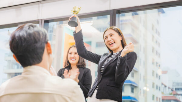 Business woman holding award trophy at meeting room, Celebration success happiness team concept stock photo