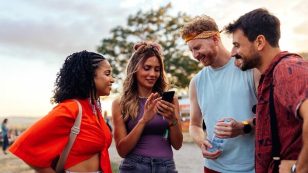 Gen Z group reading a customer loyalty email from their festival provider.